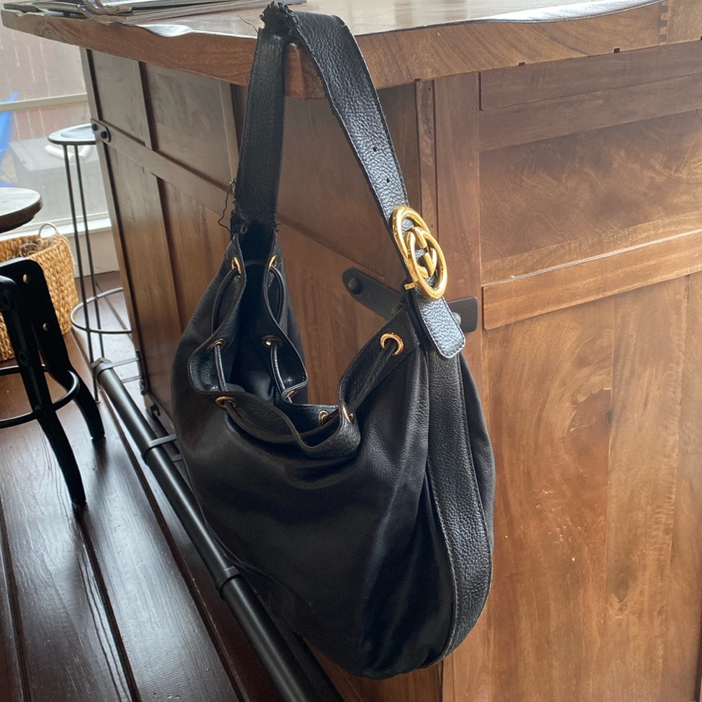 Gucci Black Leather Shoulder Bag with Tassels. Inside zipper and pockets.